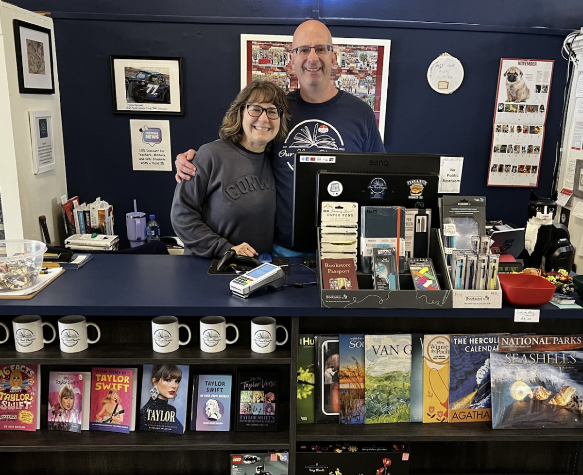 Owners Bob and Lisa Martire pose behind the cash register.